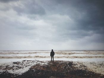 Silhouette of people standing on beach