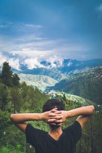 Man standing on mountain against sky