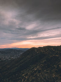 Scenic view of dramatic sky over landscape during sunset