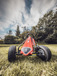 Close-up of tractor on field against sky