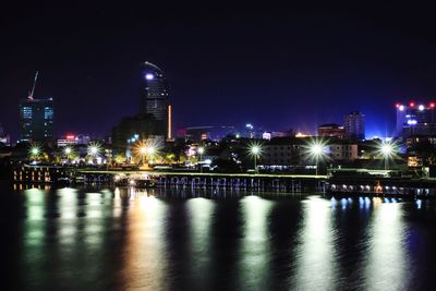Illuminated city at waterfront