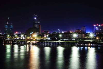 Illuminated city at waterfront