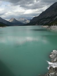 Scenic view of lake and mountains against sky