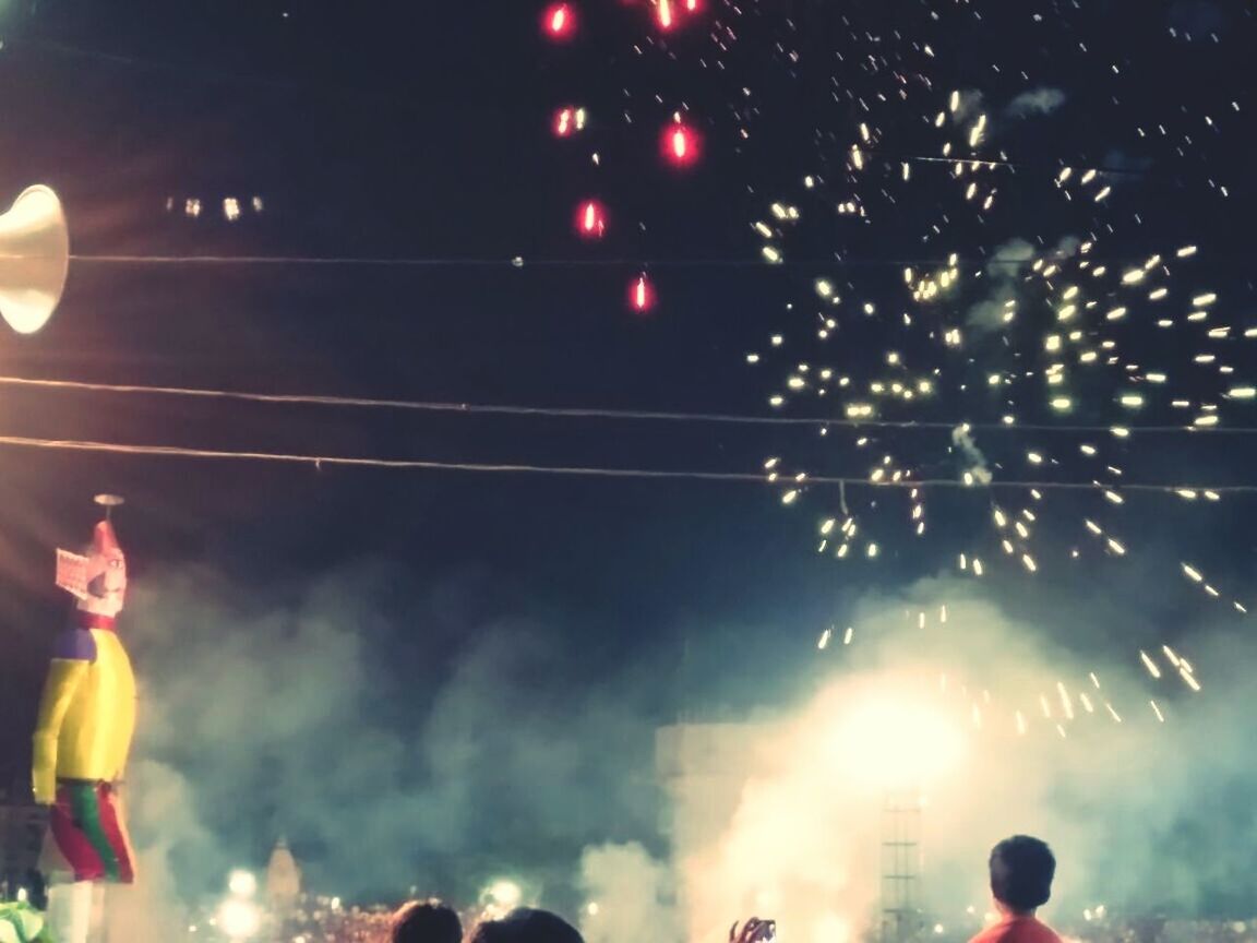 LOW ANGLE VIEW OF FIREWORK DISPLAY AT NIGHT DURING FESTIVAL