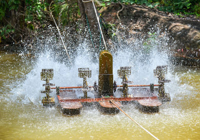 Water splashing on boat in river