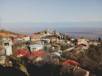 High angle view of houses in town against sky