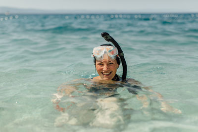 Portrait of woman swimming in sea