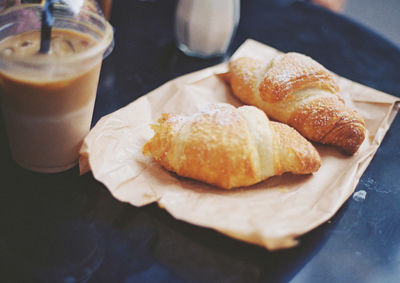Close-up of croissant and coffee on table