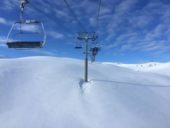 Overhead cable cars on snow covered landscape