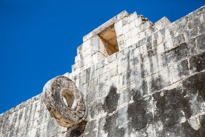 Low angle view of old ruin against clear blue sky