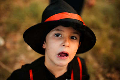 Close-up portrait of boy wearing hat during halloween at forest