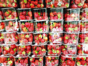 Full frame shot of strawberries in containers for sale
