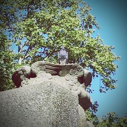 Low angle view of statue against blue sky