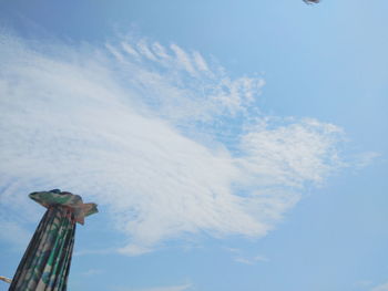 Low angle view of chain swing ride against sky