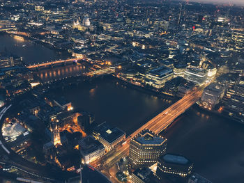 High angle view of illuminated city buildings at night