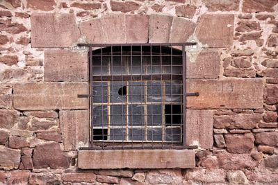 Brick wall with closed, broken window