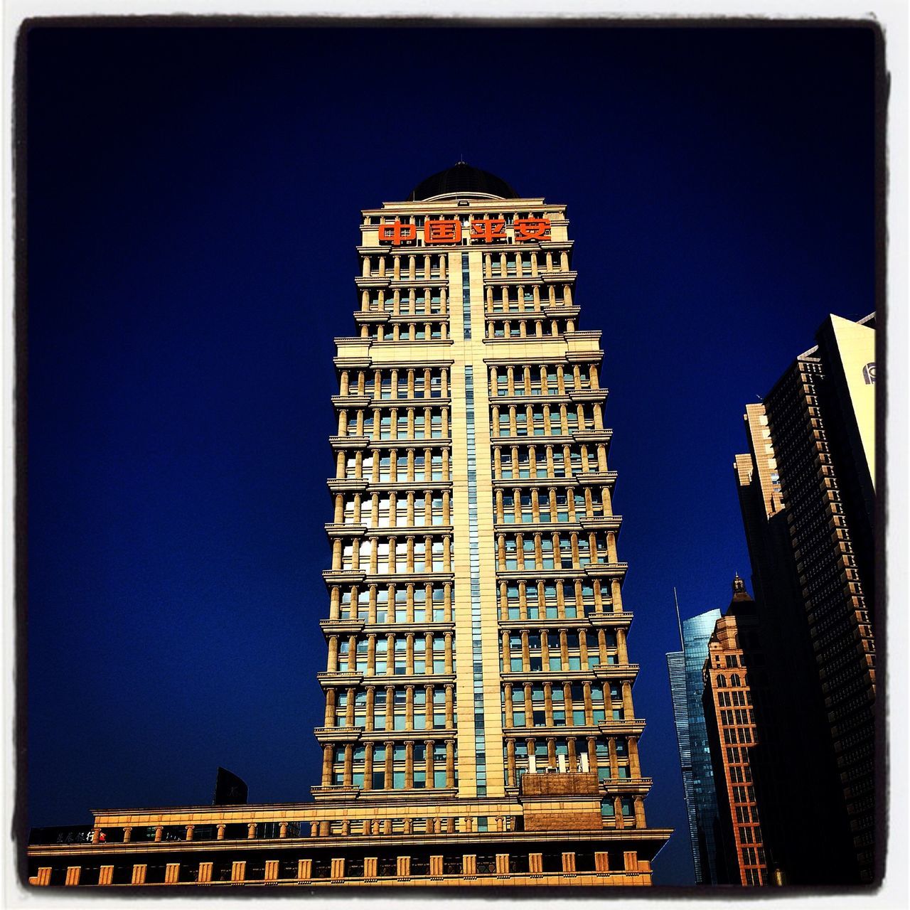 architecture, building exterior, built structure, low angle view, transfer print, clear sky, blue, auto post production filter, city, tower, tall - high, building, copy space, sky, outdoors, travel destinations, tall, famous place, skyscraper, capital cities