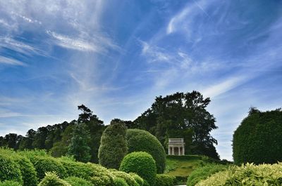 Scenic view of grassy field against cloudy sky