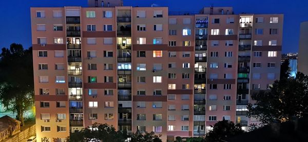 Low angle view of buildings against sky at night