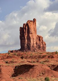 View of rocky cliff against cloudy sky