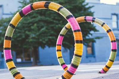 Colorful bicycle rack on street against buildings