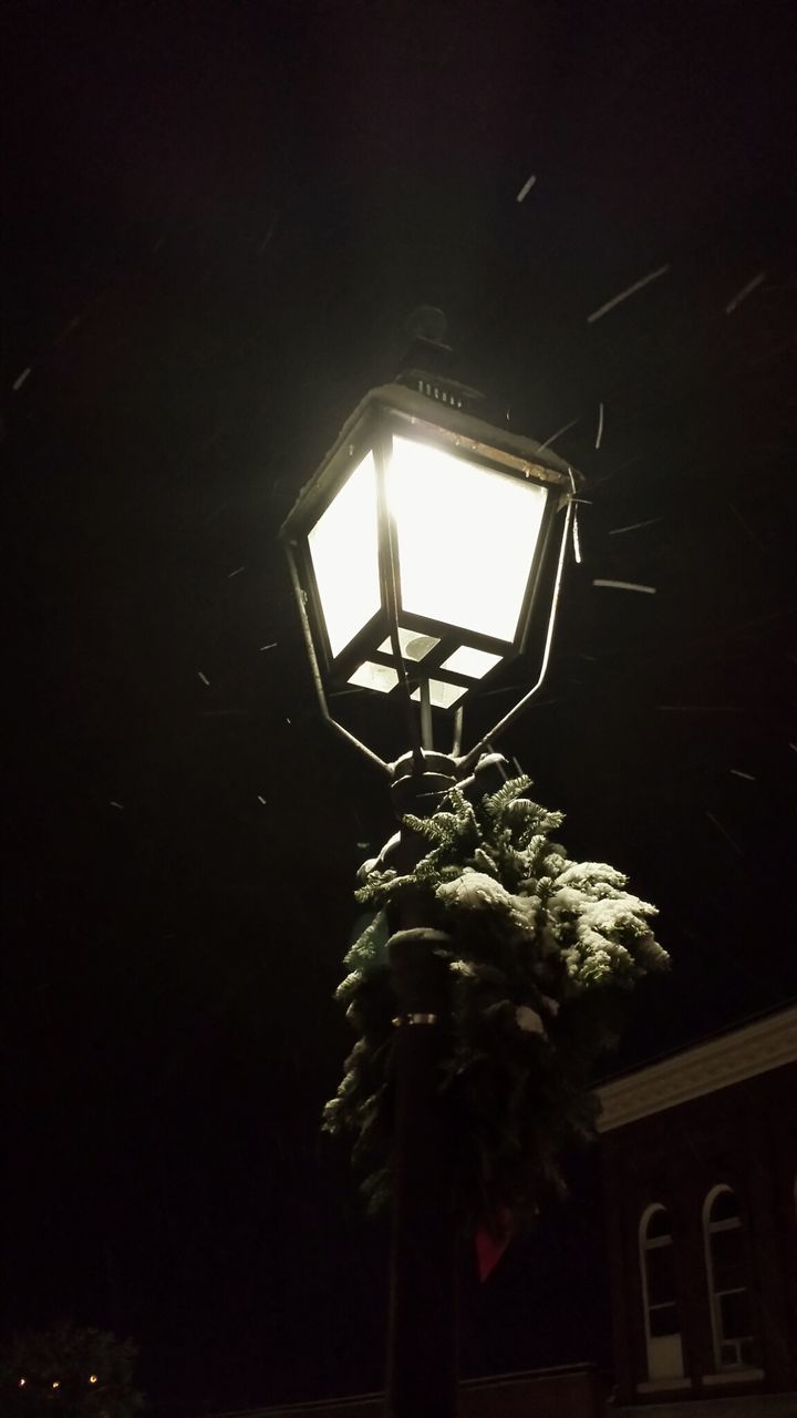 low angle view, lighting equipment, illuminated, night, built structure, architecture, dark, electricity, window, building exterior, street light, house, electric lamp, no people, religion, tree, copy space, lantern, glowing