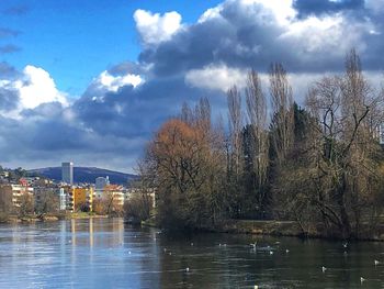 Scenic view of lake by buildings against sky