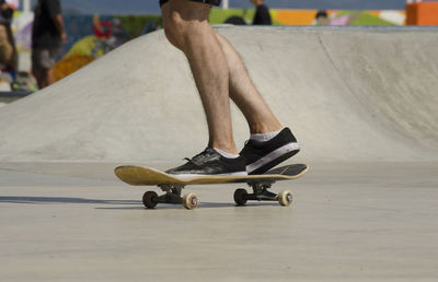 Low section of man skateboarding outdoors