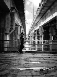 Man standing on street by old building