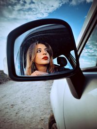 Portrait of young woman in car
