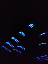 Low angle view of illuminated lights at night