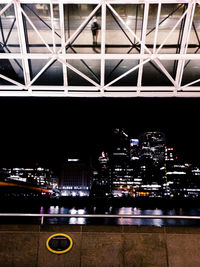 Illuminated modern buildings against sky at night