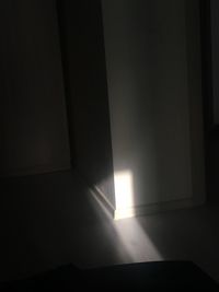 Sunlight streaming through window in dark room