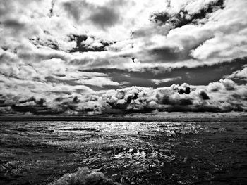 Scenic view of sea against cloudy sky