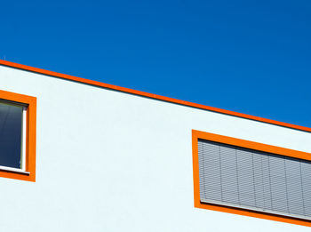 Low angle view of building against clear blue sky