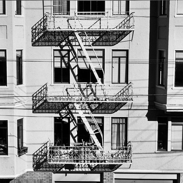 building exterior, architecture, built structure, window, building, residential building, residential structure, low angle view, city, balcony, railing, house, day, outdoors, no people, staircase, steps, apartment, sunlight, reflection