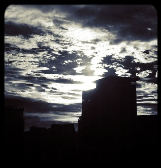 silhouette, sky, building exterior, cloud - sky, architecture, built structure, cloudy, sunset, cloud, low angle view, dusk, outline, dark, dramatic sky, city, auto post production filter, transfer print, weather, building, outdoors