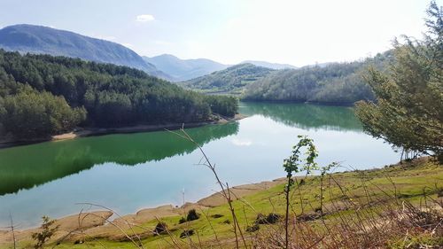 Scenic view of lake and mountains against sky