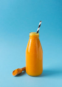 Close-up of drink against blue background