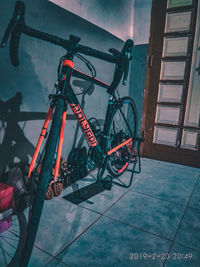 High angle view of bicycle parked against wall in city