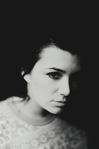 Close-up portrait of young woman looking away