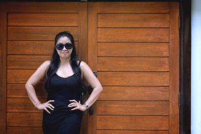 Portrait of young woman wearing sunglasses standing outdoors