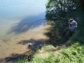 High angle view of young woman on riverbank