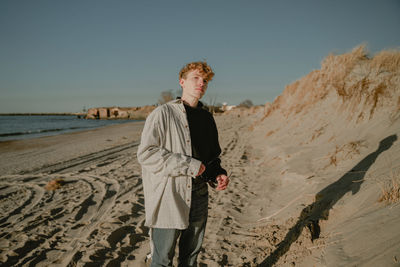 Young man standing at beach