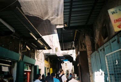 Narrow street amidst buildings in city against sky