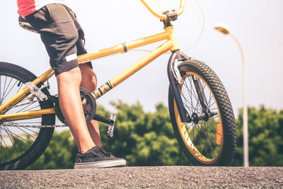 Low section of boy sitting on bicycle at sports ramp