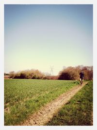 People walking on grassy field