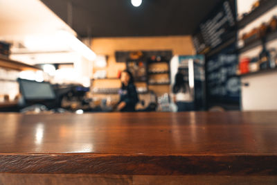 Close-up of illuminated light bulb on table in restaurant