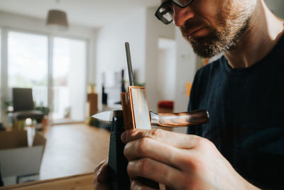 Midsection of man working in kitchen