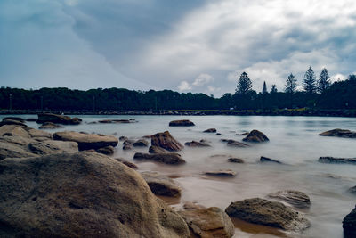 Rocks on shore against sky